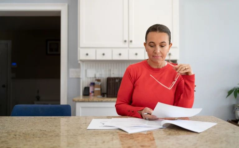 person reviewing financial documents at home related to spousal maintenance modification